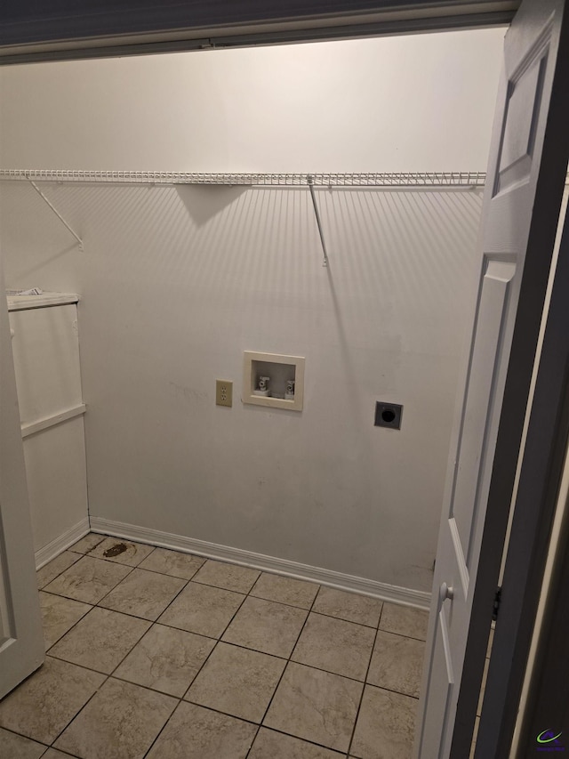 clothes washing area featuring electric dryer hookup, hookup for a washing machine, and light tile patterned floors