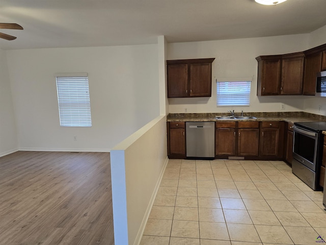 kitchen with sink, light hardwood / wood-style flooring, ceiling fan, appliances with stainless steel finishes, and dark brown cabinets