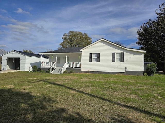 back of house with a porch, a garage, an outdoor structure, and a yard