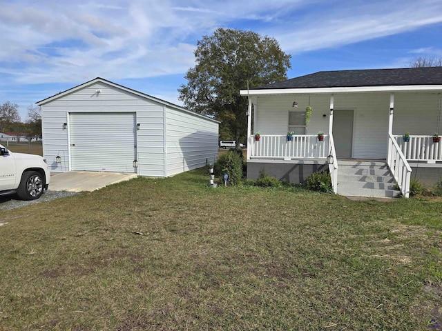 view of front of property with an outbuilding, a porch, a garage, and a front lawn