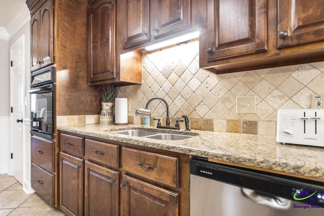 kitchen with oven, sink, stainless steel dishwasher, ornamental molding, and light tile patterned floors