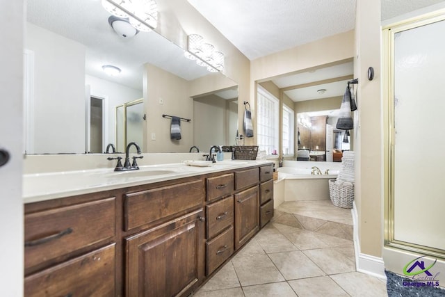 bathroom featuring tile patterned floors, vanity, shower with separate bathtub, and a textured ceiling