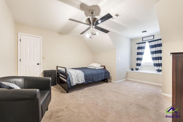 carpeted bedroom featuring ceiling fan, a textured ceiling, and vaulted ceiling