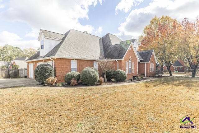 view of front of property featuring a garage and a front lawn