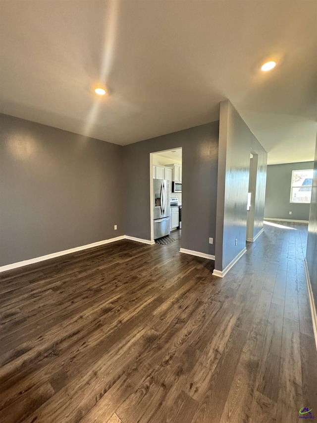 unfurnished room featuring dark wood-type flooring