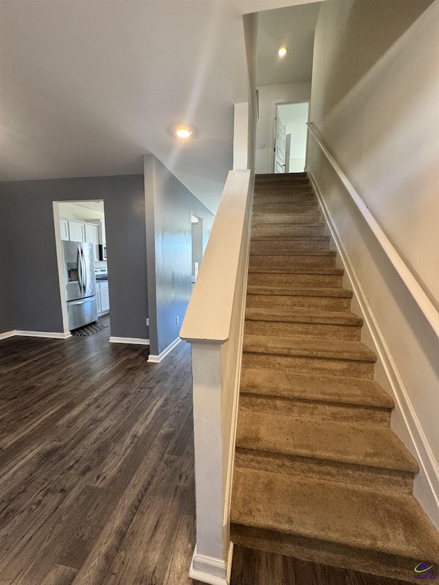 stairs with hardwood / wood-style flooring