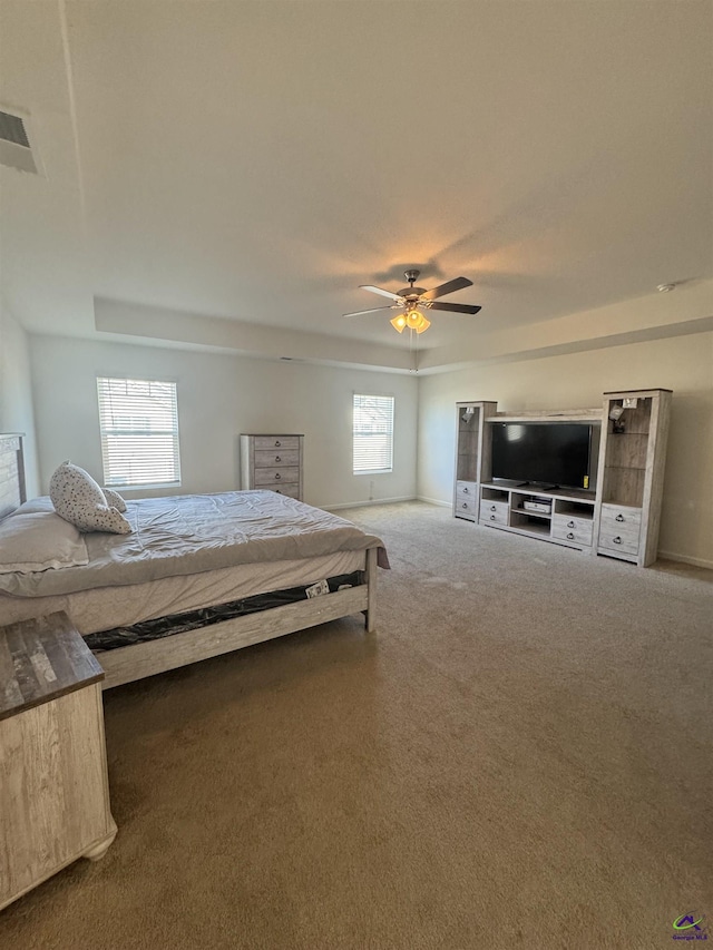 carpeted bedroom with ceiling fan and multiple windows