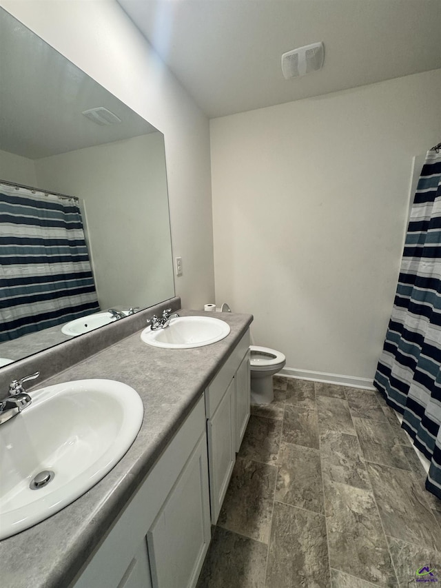 bathroom with vanity, a shower with shower curtain, and toilet