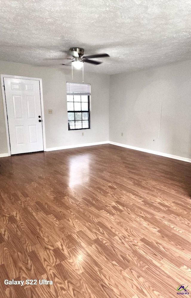 spare room featuring ceiling fan, hardwood / wood-style floors, and a textured ceiling