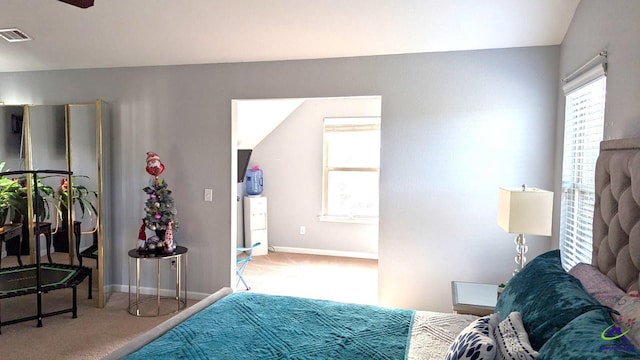 bedroom with carpet flooring and lofted ceiling