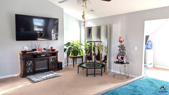 living area with light carpet, ceiling fan, and lofted ceiling