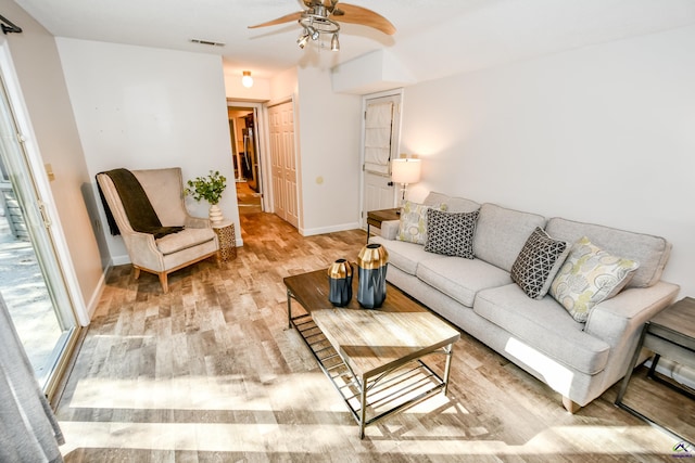 living room featuring ceiling fan and light hardwood / wood-style flooring