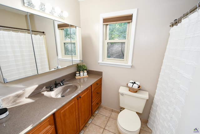 bathroom with tile patterned flooring, vanity, and toilet