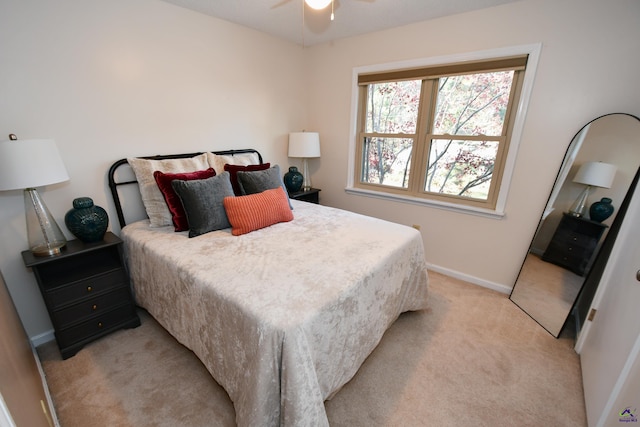 bedroom with ceiling fan and light carpet