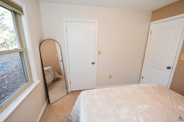 carpeted bedroom with a textured ceiling