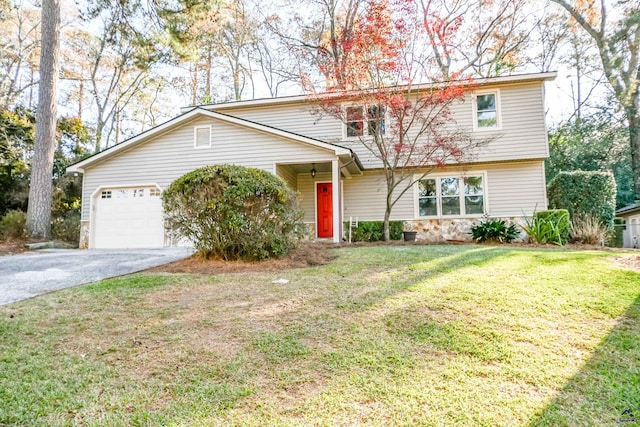 view of property featuring a front lawn and a garage