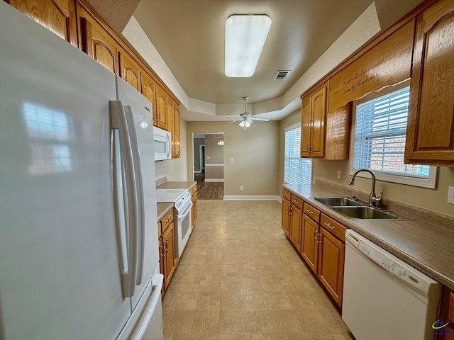 kitchen with ceiling fan, sink, and white appliances