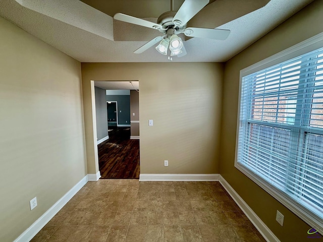 empty room featuring a textured ceiling and ceiling fan