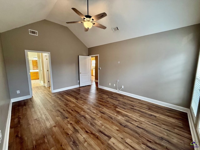 unfurnished bedroom with ceiling fan, wood-type flooring, ensuite bathroom, and vaulted ceiling