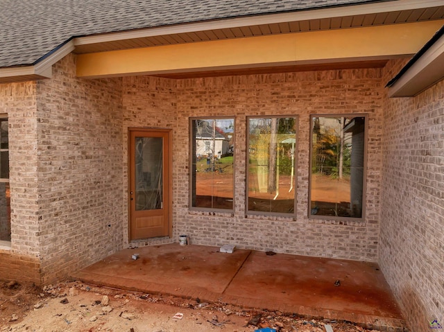 view of exterior entry featuring a patio