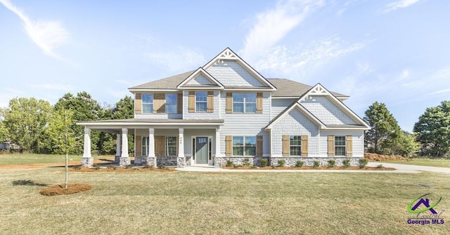 500 Bella Notte Cir, Warner Robins, GA 31088 - craftsman-style home featuring a porch, a front lawn, and stone siding