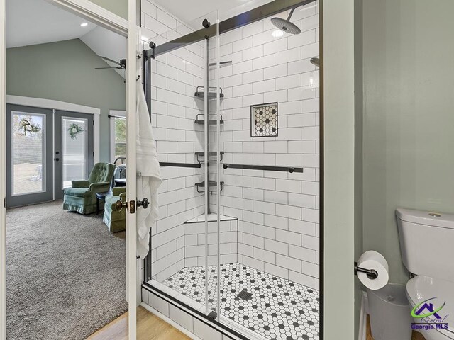 bathroom featuring an enclosed shower, vaulted ceiling, ceiling fan, hardwood / wood-style flooring, and toilet