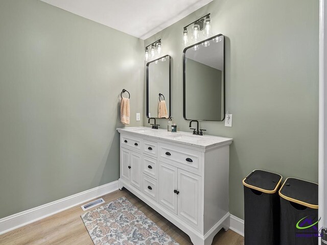 bathroom featuring vanity and wood-type flooring