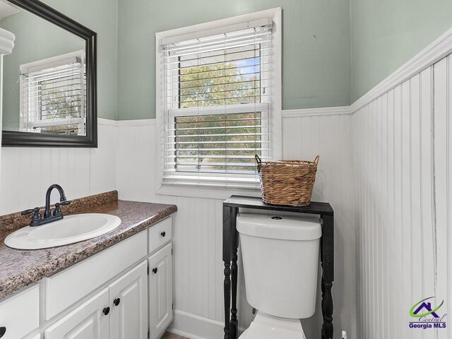 bathroom featuring vanity and toilet