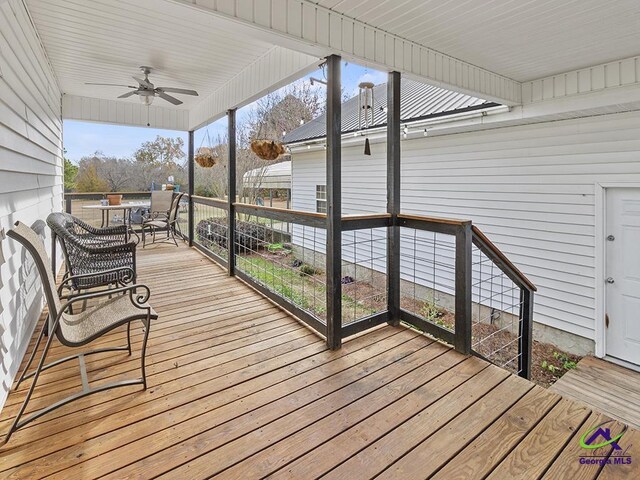 wooden terrace featuring ceiling fan