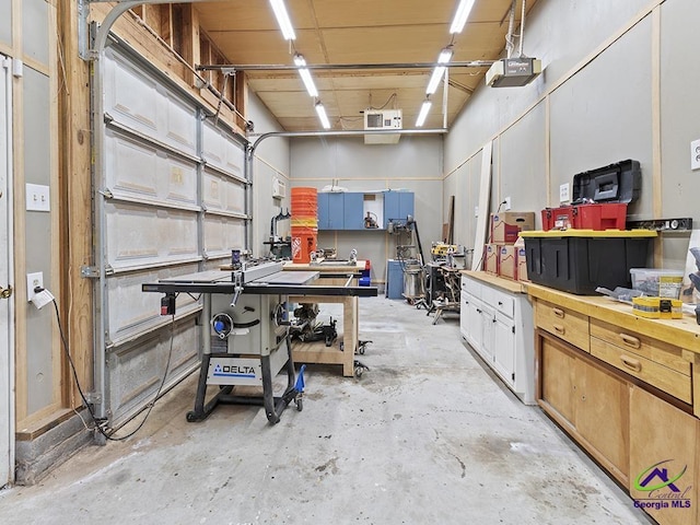 garage featuring a workshop area and a garage door opener