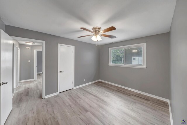 unfurnished bedroom with ceiling fan and light hardwood / wood-style floors