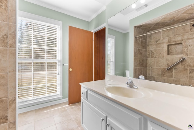 bathroom with tiled shower, tile patterned flooring, plenty of natural light, and ornamental molding