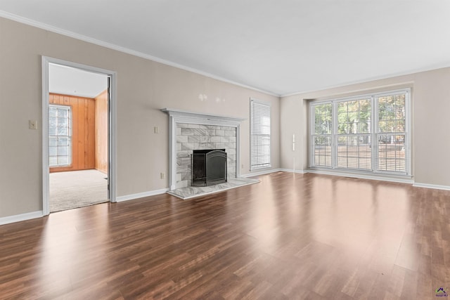 unfurnished living room featuring hardwood / wood-style floors, crown molding, and a fireplace