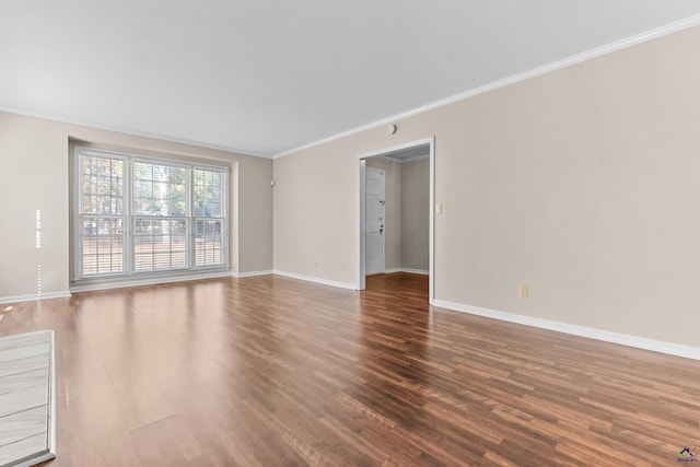 empty room with wood-type flooring and crown molding