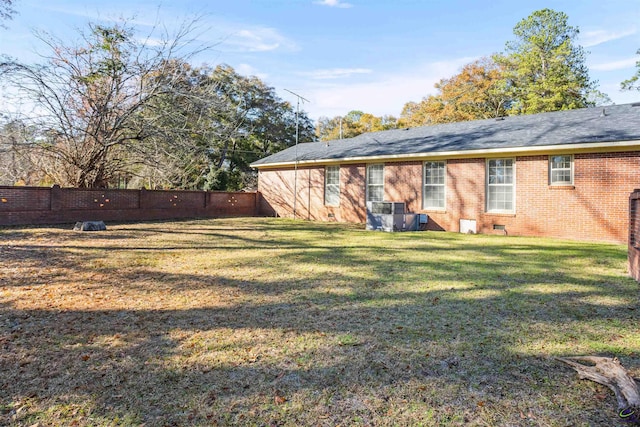 rear view of house featuring a yard