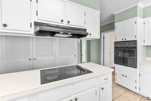 kitchen featuring light tile patterned floors, white cabinetry, ornamental molding, and black appliances