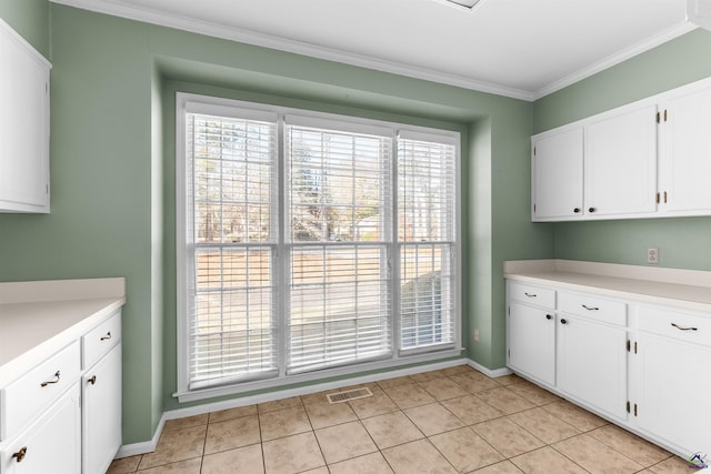 interior space featuring light tile patterned floors and ornamental molding