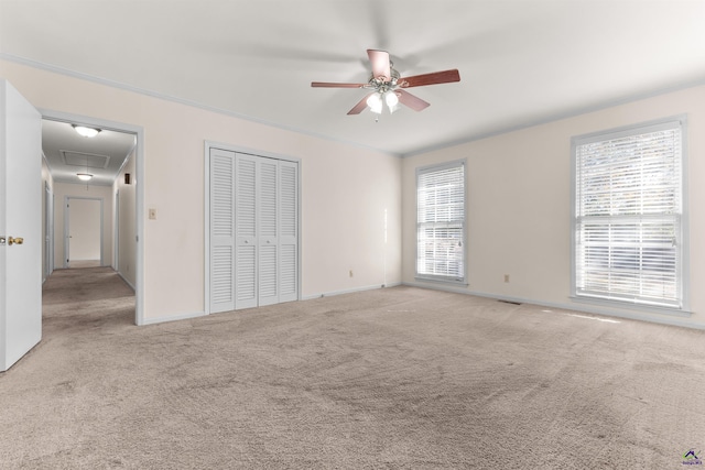 unfurnished bedroom featuring ceiling fan and light colored carpet