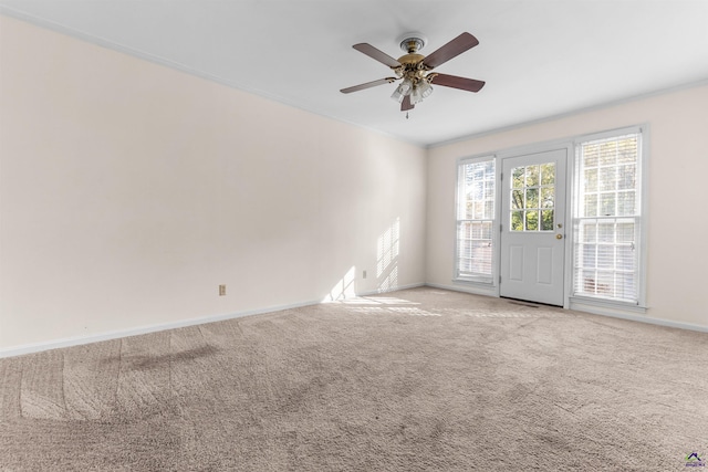 carpeted spare room with ceiling fan