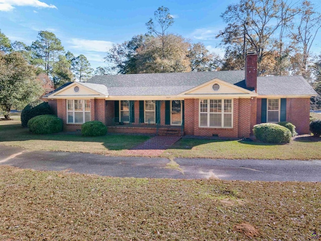 ranch-style home with a porch and a front yard