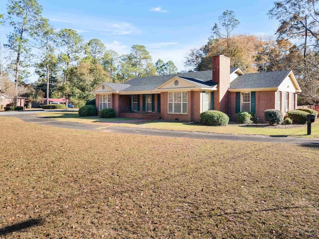 ranch-style home featuring a front yard