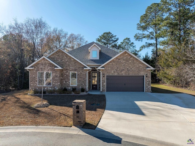 view of front of home featuring a front yard and a garage