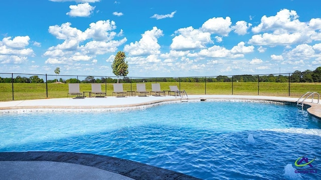 view of swimming pool featuring a yard and a patio