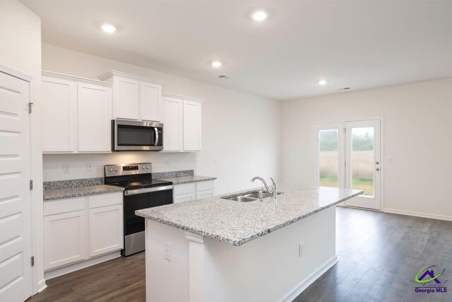 kitchen with white cabinets, sink, an island with sink, dark hardwood / wood-style flooring, and stainless steel appliances