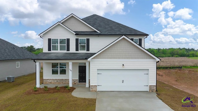 craftsman house with a garage, central air condition unit, and a front lawn