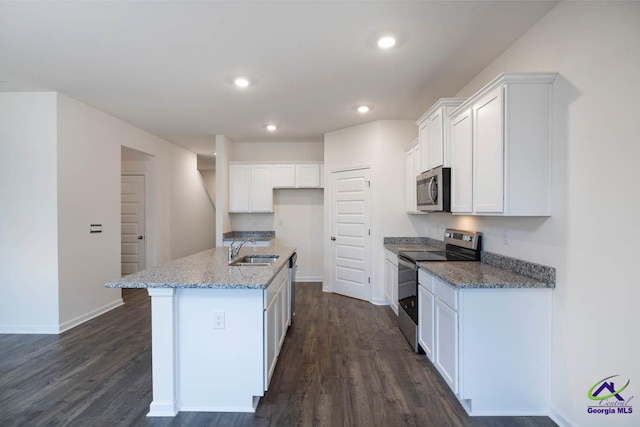 kitchen featuring white cabinetry, an island with sink, dark hardwood / wood-style floors, and appliances with stainless steel finishes