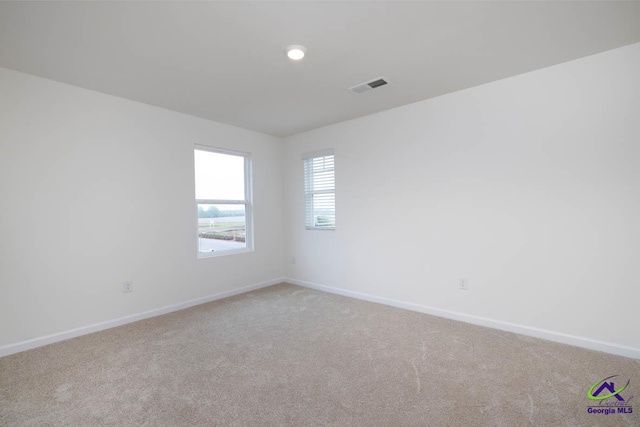 unfurnished room with light colored carpet