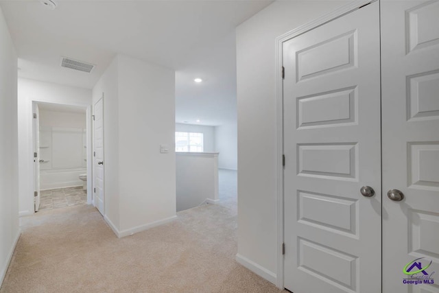 corridor with light colored carpet