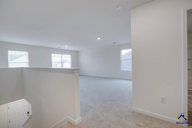 unfurnished room featuring light colored carpet