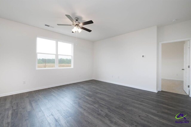 empty room featuring dark hardwood / wood-style floors and ceiling fan